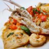 Crab ravioli with prawn, chilli and tomato vinaigrette.