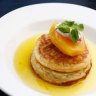 House-made crumpets with stawberry labna and poached pears.