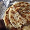 A man eats a traditional Pakistani breakfast of curried chickpeas and paratha bread in Karachi SPECIAL 234