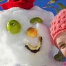 Cool fun ... children finesse their snowman.