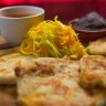 Pupusas with refried beans and pickled cabbage.