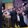 A notorious Australian public nuisance evaded security to ambush shocked actress Ariana Grande on the yellow carpet in Singapore.