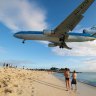 Sint Maarten a plane flies low over Maho Beach into the airport.