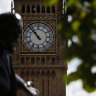 The statue of former British Prime Minister David Lloyd George is silhouetted against the Queen Elizabeth Tower which holds the bell known as 'Big Ben' in London.