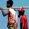 Young vendors look to sell their wares on a beach in Dili.