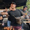 Taste that: Budz leads the cooking team at the Hoy Pinoy Filipino barbecue at the Lunar Markets.
