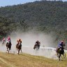 Big day out ...  crowds boot home a winner at the Buchan Race Course. 