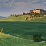 a dirt road leads to this villa near the village of Pienza in Val d'Orcia (a World Heritage Site); Tuscany, Italy.