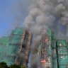 Three men have been arrested on suspicion of manslaughter over a fire that continues to burn across multiple high-rise apartment buildings in a Hong Kong housing complex, killing at least 44 people with nearly 300 missing.